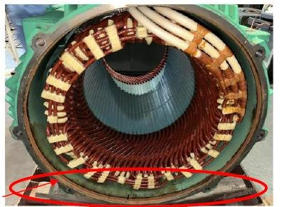 Stator of the 355 kW motor at inspection, with rust marks at the spigot location circled